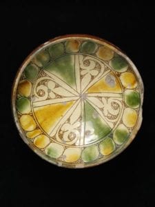 1300 1499. Bowl red earthenware covered with a white slip incised splashed in green and amber and covered with a clear lead glaze Byzantine Cyprus 14th or 15th century. Museum Number C.22 1936.